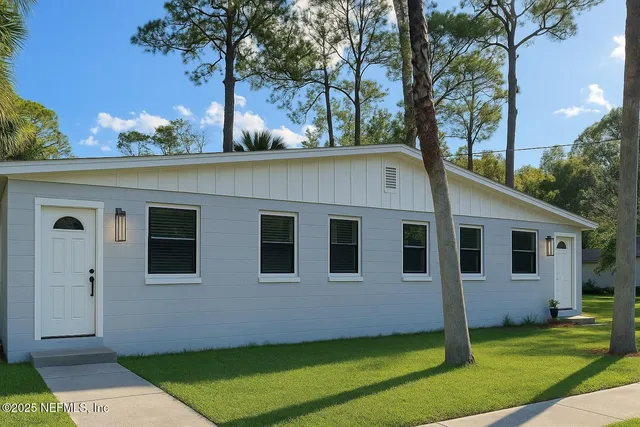 a house that has a tree in front of the house
