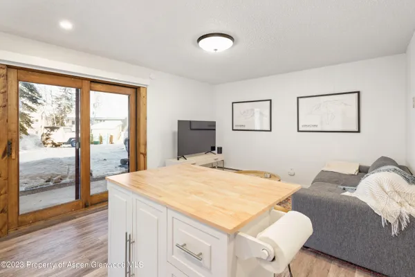 a living room with a bed furniture and next to a window