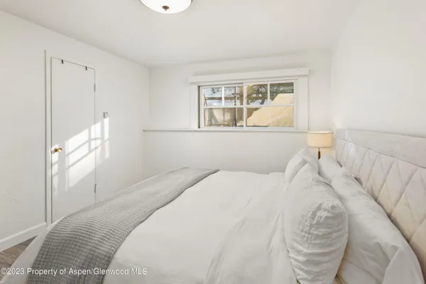 a bedroom with a large bed and a window