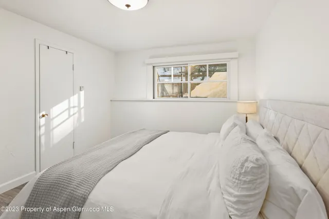 a bedroom with a large bed and a window