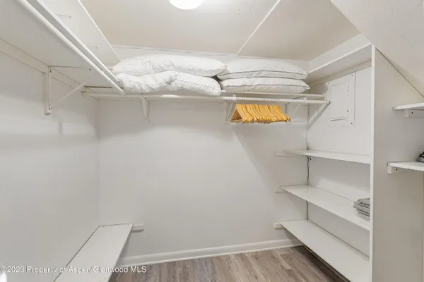 a view of walk in closet with empty racks
