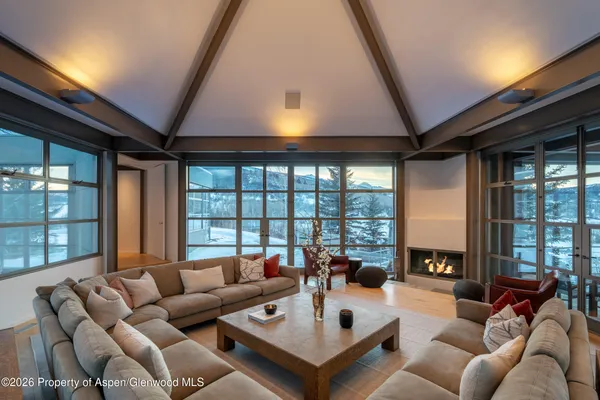 a living room with furniture and a floor to ceiling window