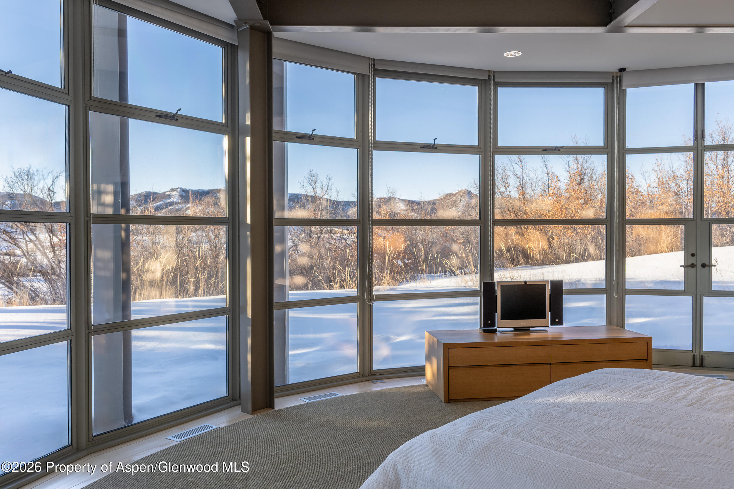 821 Cluny Road Aspen, CO 81611 - Photo 19 of 27 a bedroom with furniture and a window