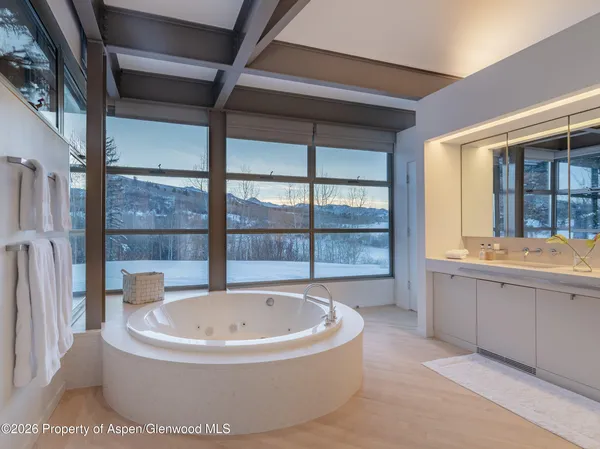 a bedroom with furniture and a large window