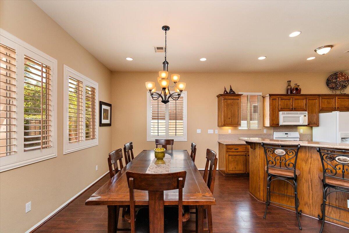 49580 Wayne Street Indio, CA 92201 - Photo 11 of 37 a dining room filled chandelier and wooden floor