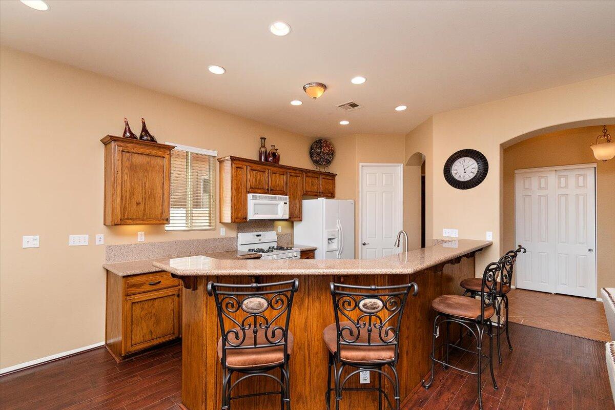 49580 Wayne Street Indio, CA 92201 - Photo 12 of 37 a view of a kitchen area with furniture and wooden floor