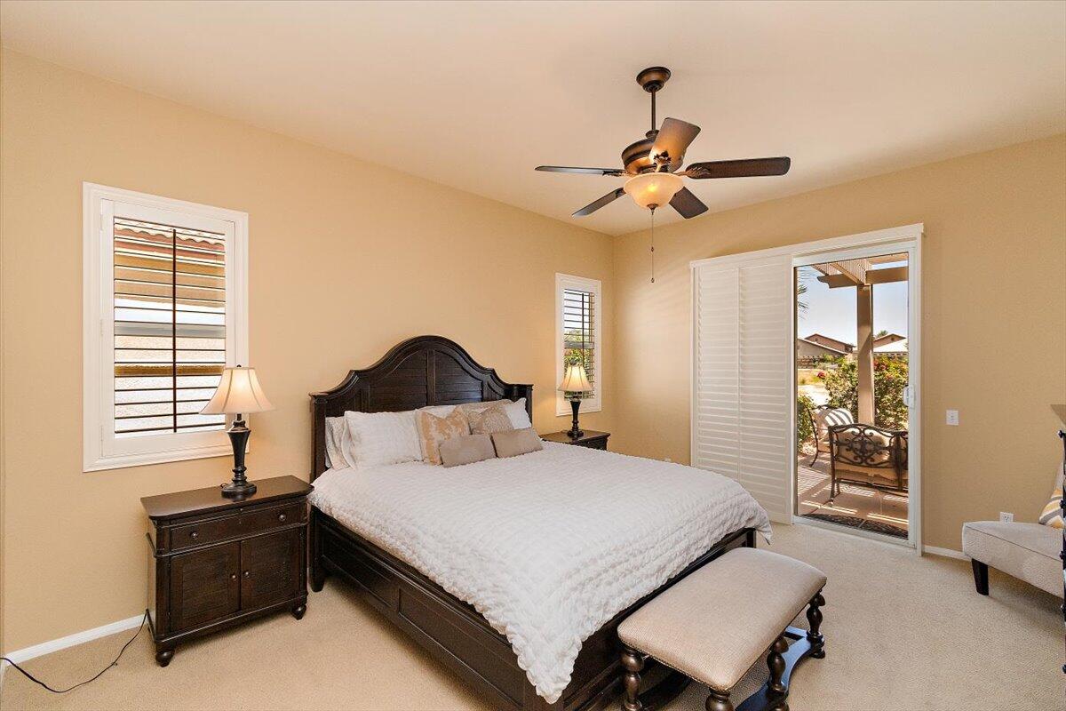 49580 Wayne Street Indio, CA 92201 - Photo 20 of 37 a bedroom with a bed and a chandelier