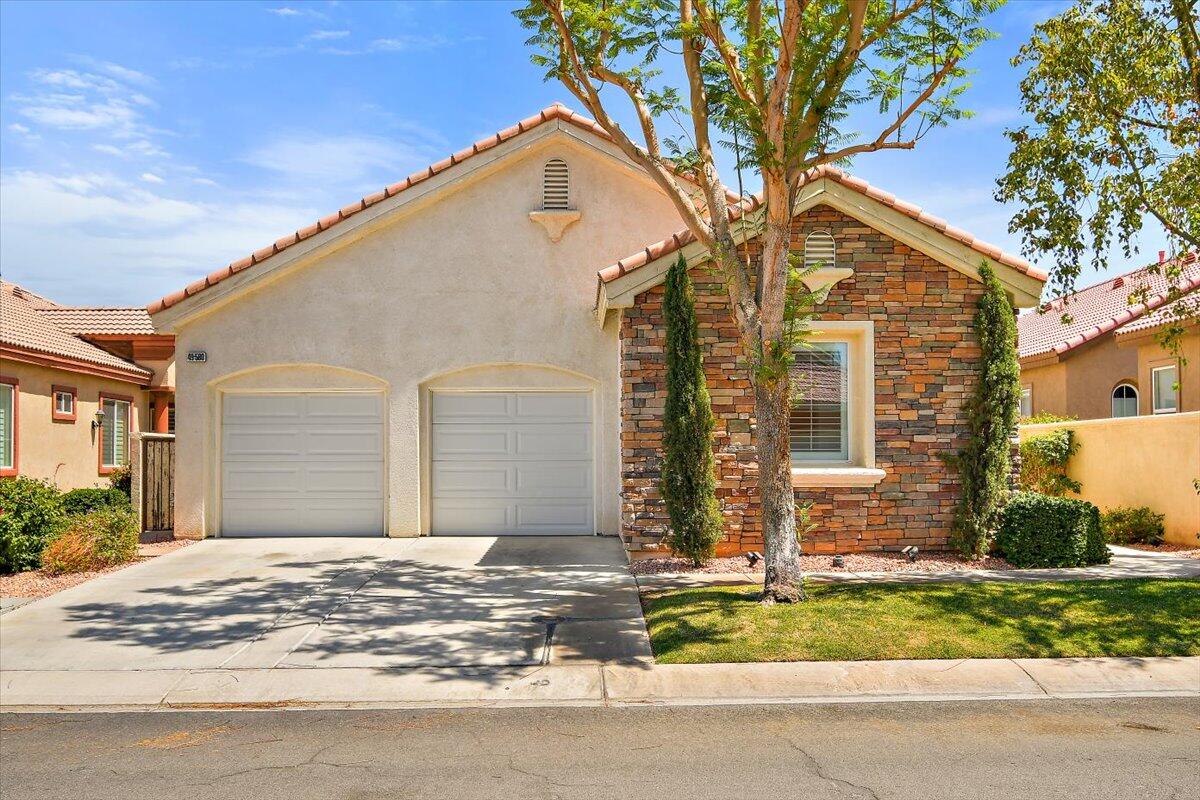 49580 Wayne Street Indio, CA 92201 - Photo 2 of 37 a front view of a house with a yard