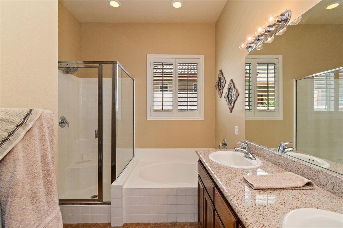 49580 Wayne Street Indio, CA 92201 - Photo 23 of 37 a bathroom with a granite countertop sink and a mirror