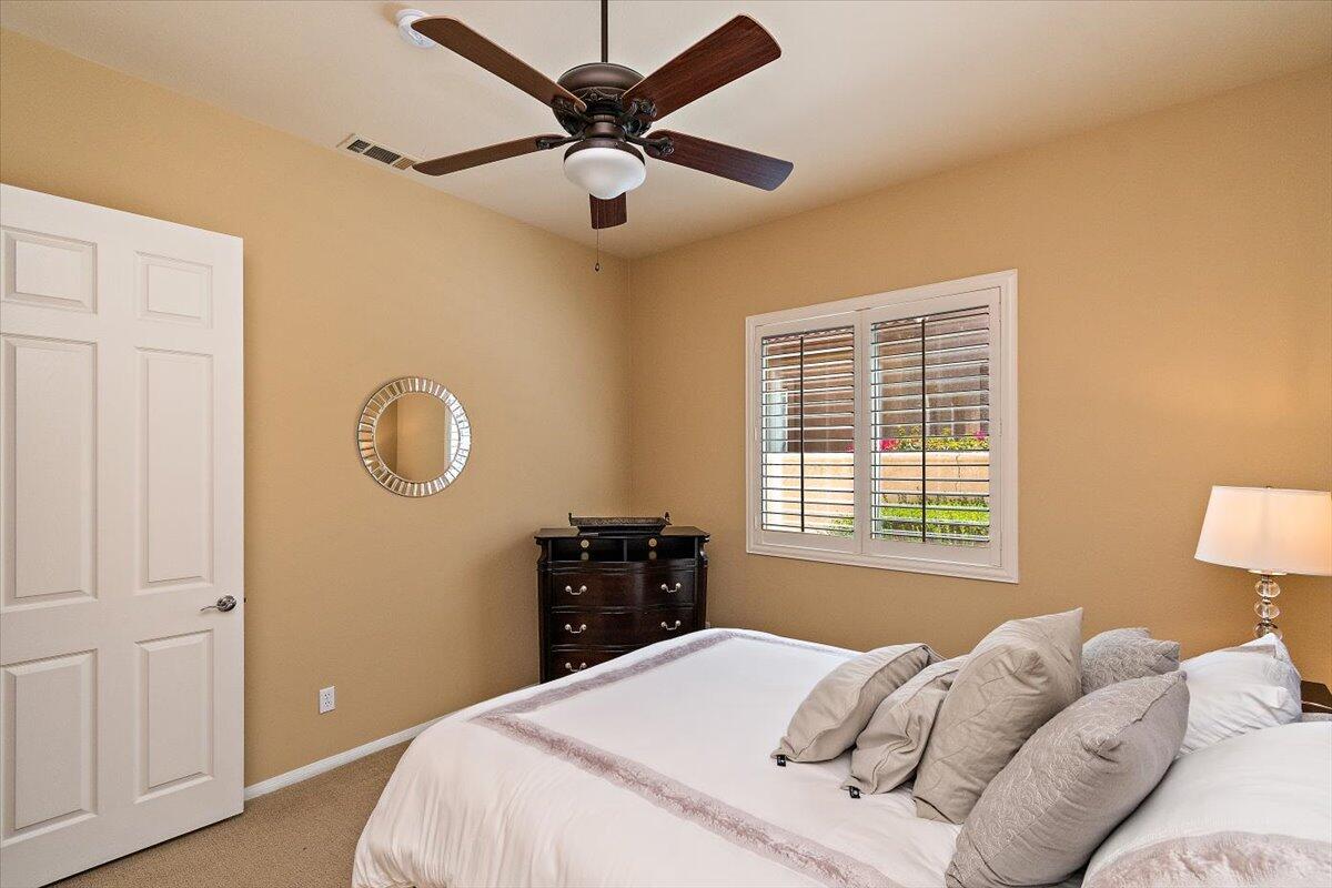 49580 Wayne Street Indio, CA 92201 - Photo 26 of 37 a bedroom with a bed and a lamp on dresser