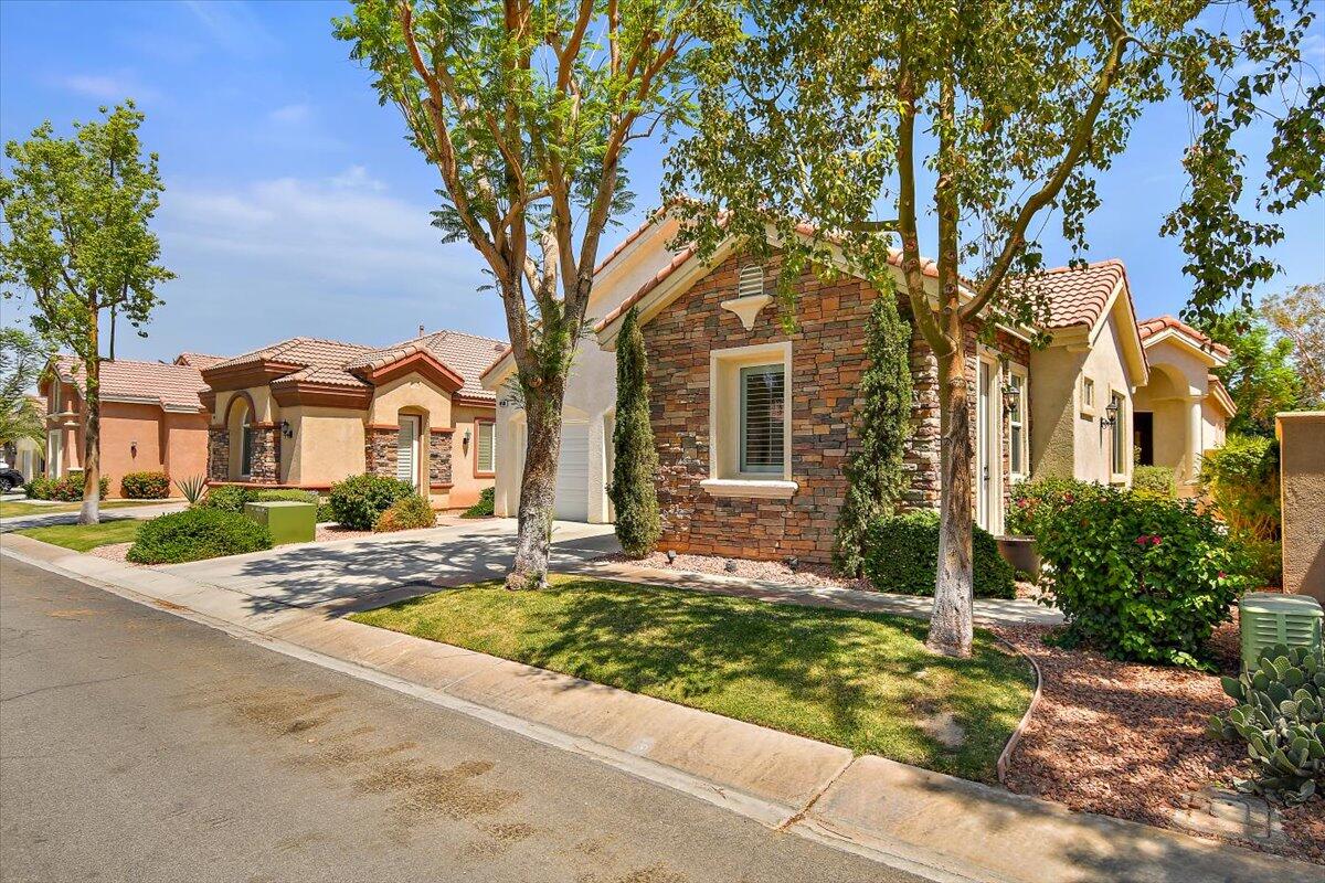 49580 Wayne Street Indio, CA 92201 - Photo 3 of 37 a front view of a house with garden
