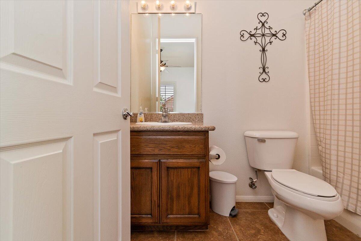 49580 Wayne Street Indio, CA 92201 - Photo 31 of 37 a bathroom with a toilet a sink and mirror