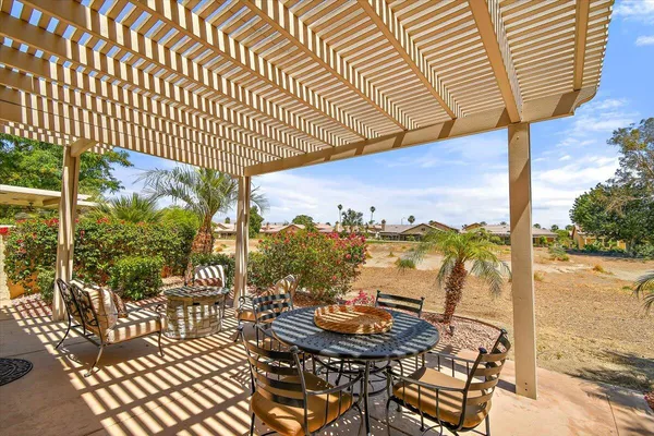 a view of a chairs and table in the patio