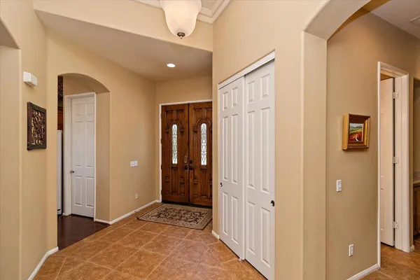 a view of a hallway with closet and bathroom