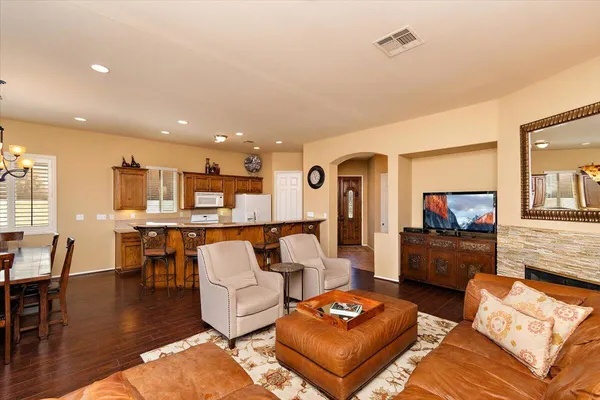 a living room with furniture and a dining table with kitchen view