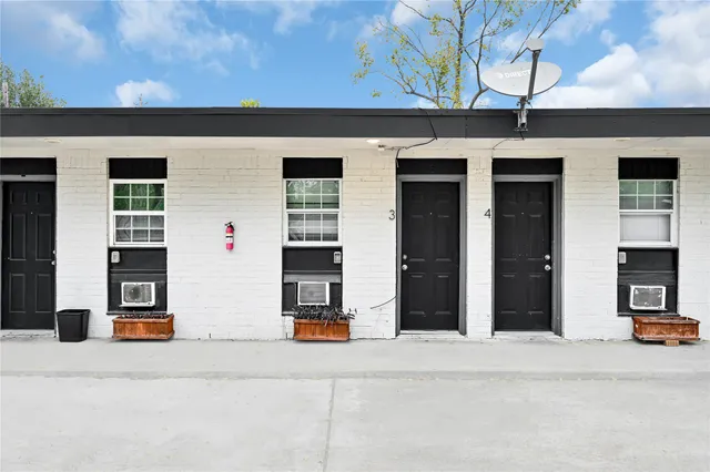 a view of a house with many windows and a table