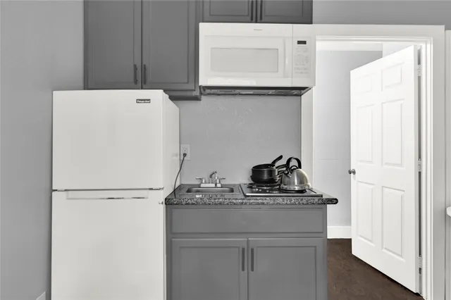 a view of a workspace with furniture and wooden floor