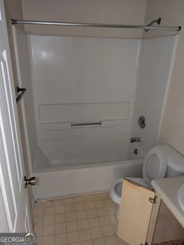 a bathroom with a shower and toilet