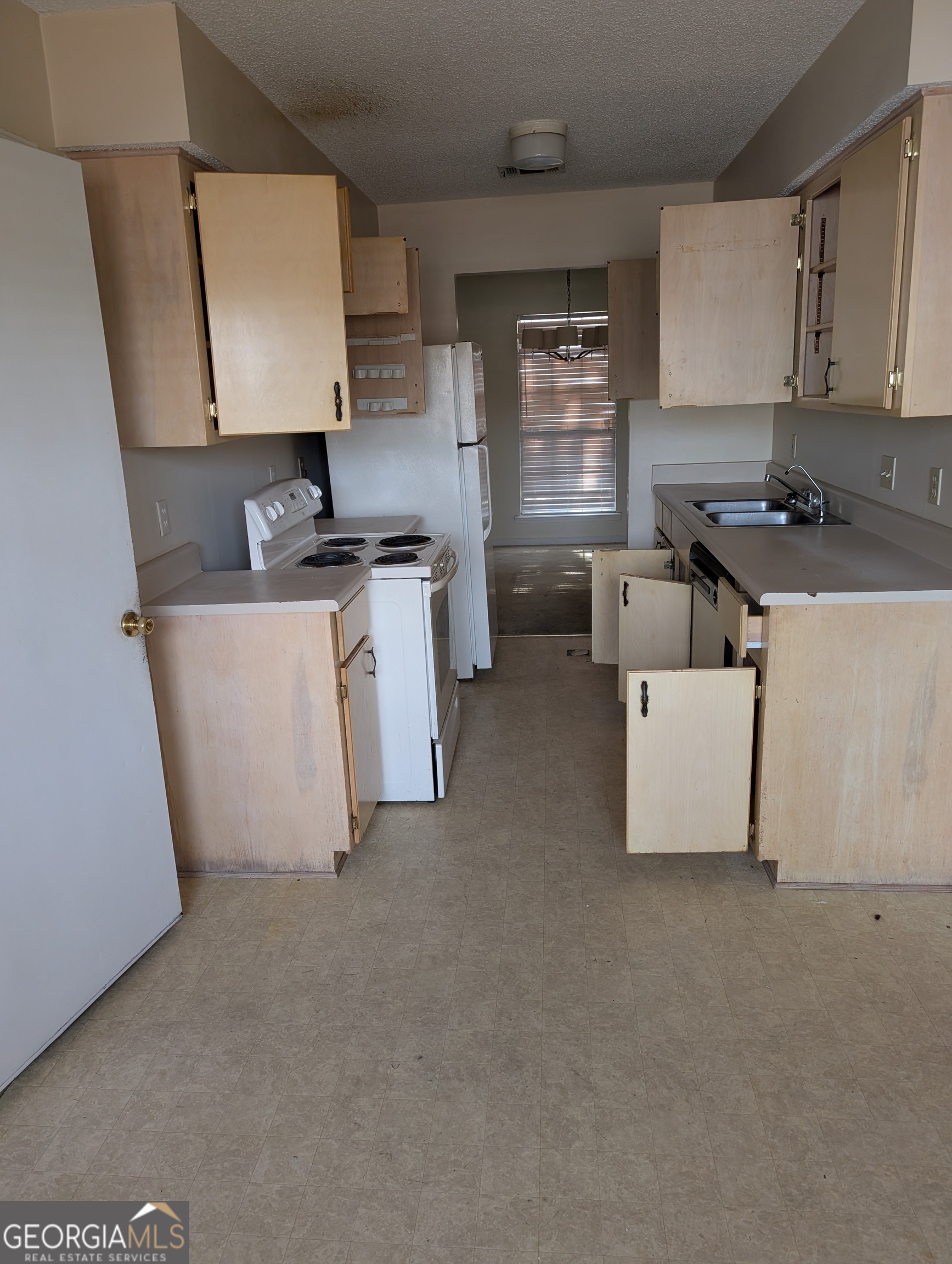 1934 Talmadge Road Allenhurst, GA 31301 - Photo 10 of 19 a kitchen with stainless steel appliances a sink a stove a refrigerator a sink a counter top space and cabinets
