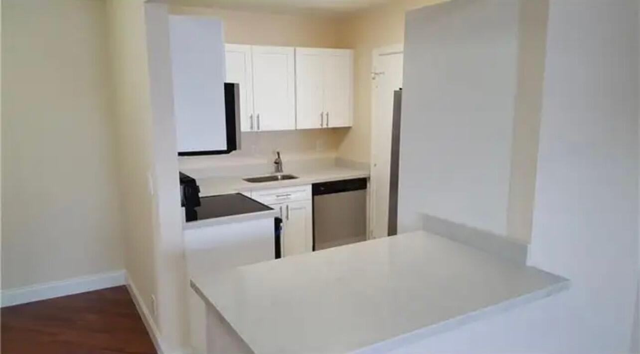 6800 Northeast 22nd Way, Unit 2121 Fort Lauderdale, FL 33308 - Photo 2 of 8 a kitchen with stainless steel appliances a sink stove and cabinets