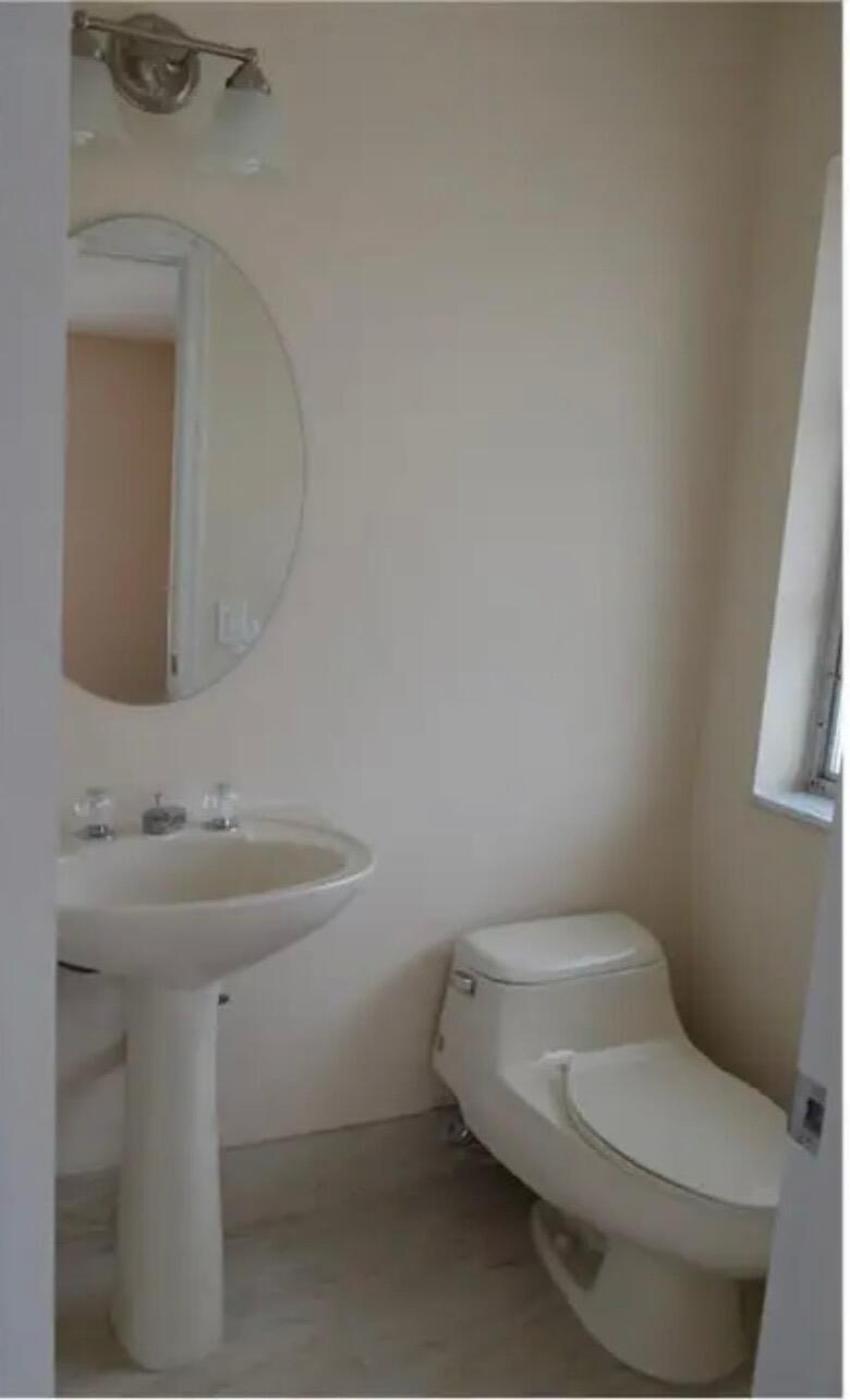 6800 Northeast 22nd Way, Unit 2121 Fort Lauderdale, FL 33308 - Photo 5 of 8 a bathroom with a sink and a toilet