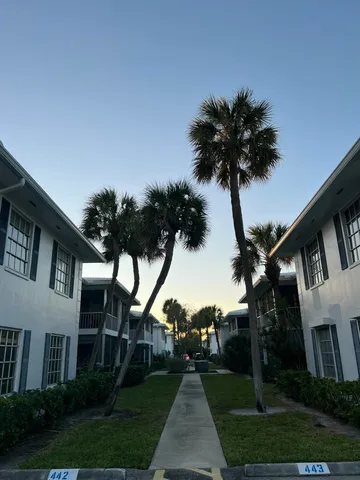 a front view of a house with a garden and a yard