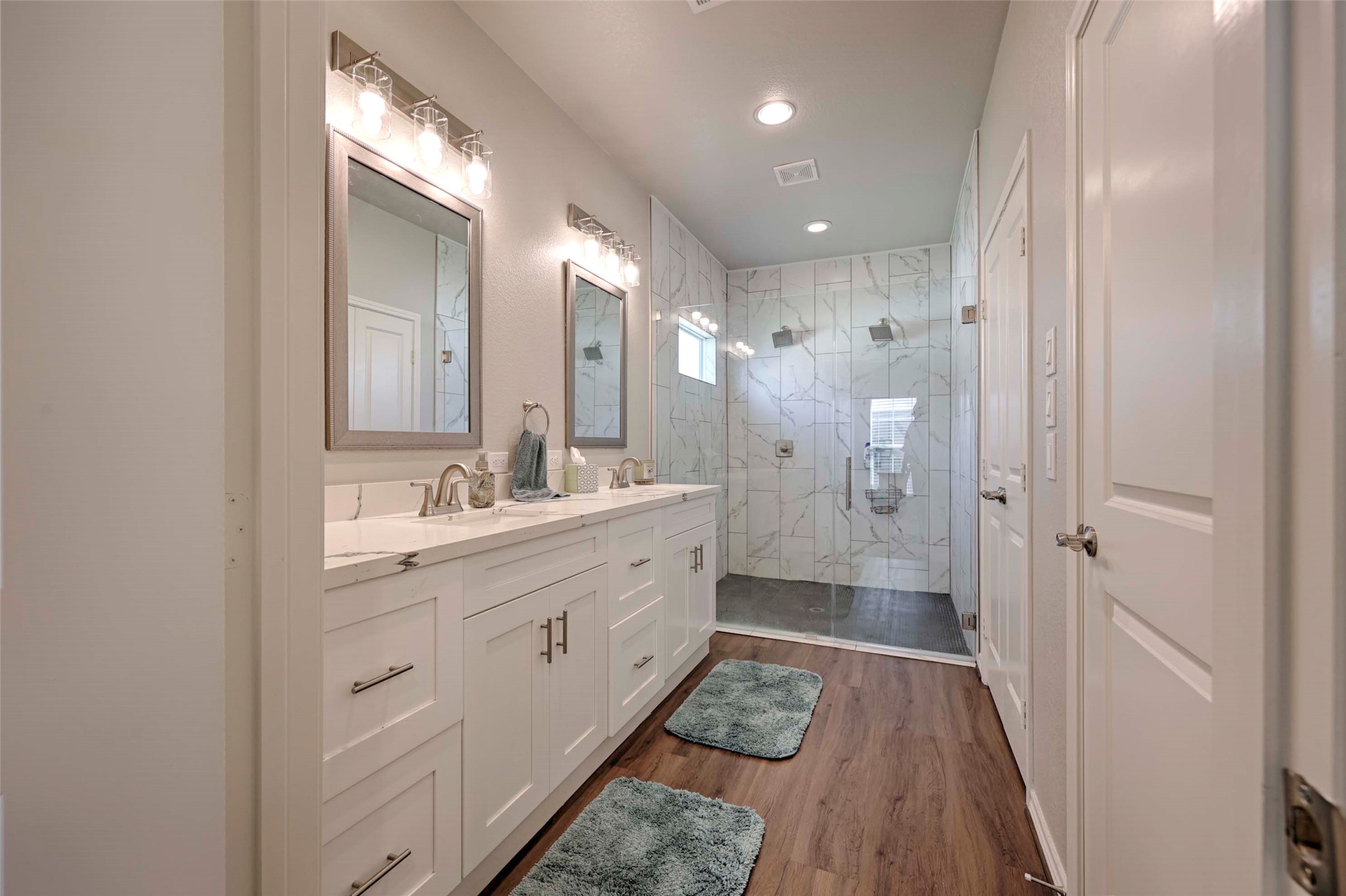 206 East Hinton Road Weimar, TX 78962 - Photo 13 of 22 Bathroom with double vanity, a marble finish shower, dark wood-style flooring, and recessed lighting