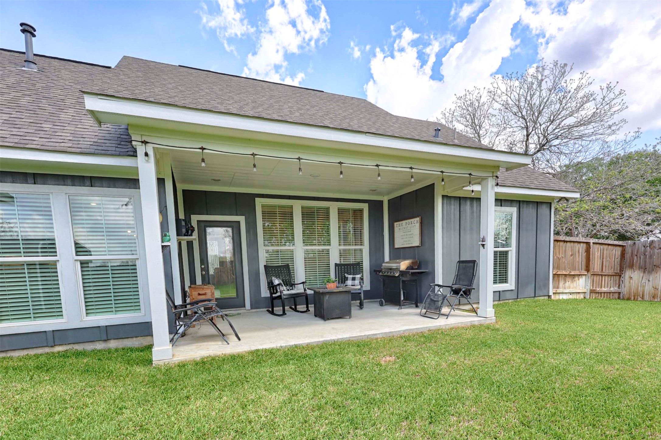 206 East Hinton Road Weimar, TX 78962 - Photo 4 of 22 Rear view of house featuring a shingled roof, a patio, and board and batten siding