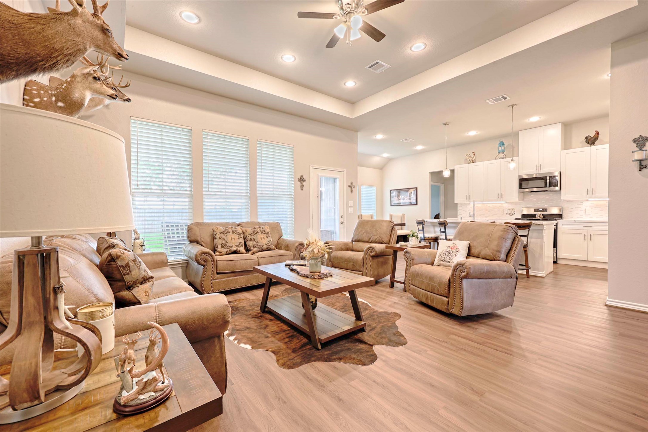 206 East Hinton Road Weimar, TX 78962 - Photo 9 of 22 Living area with a raised ceiling, a ceiling fan, light wood finished floors, and recessed lighting