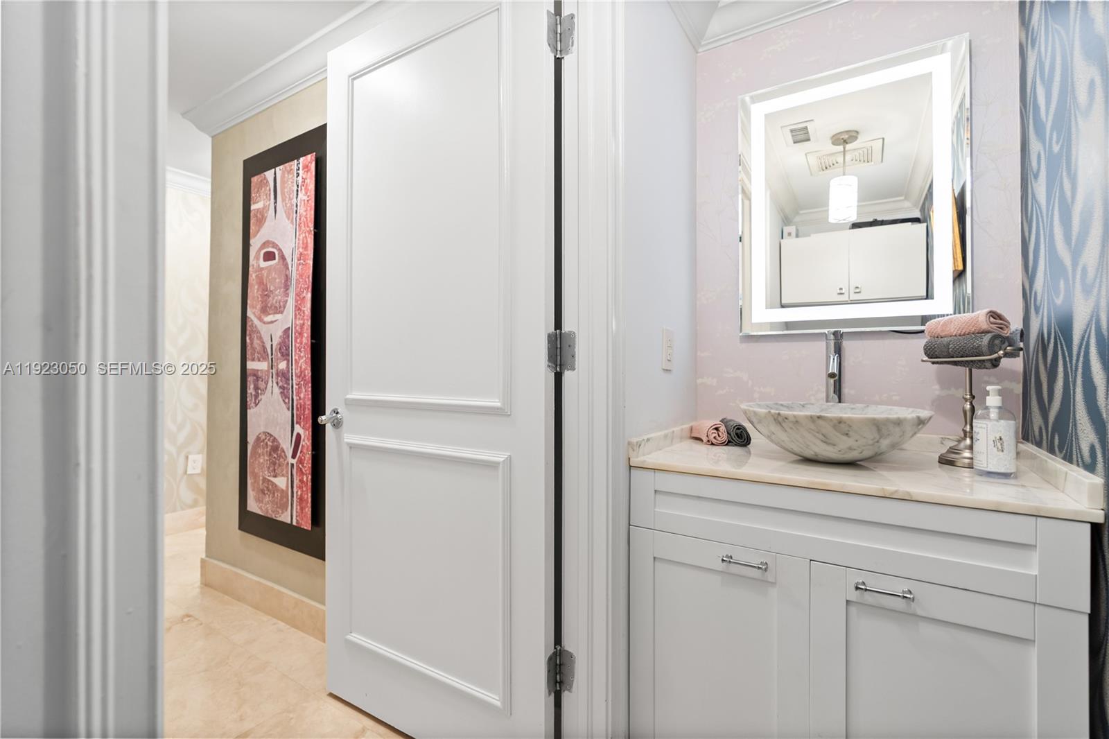 3350 Southwest 27th Avenue, Unit 1706 Coconut Grove, FL 33133 - Photo 24 of 32 a bathroom with a sink and a mirror