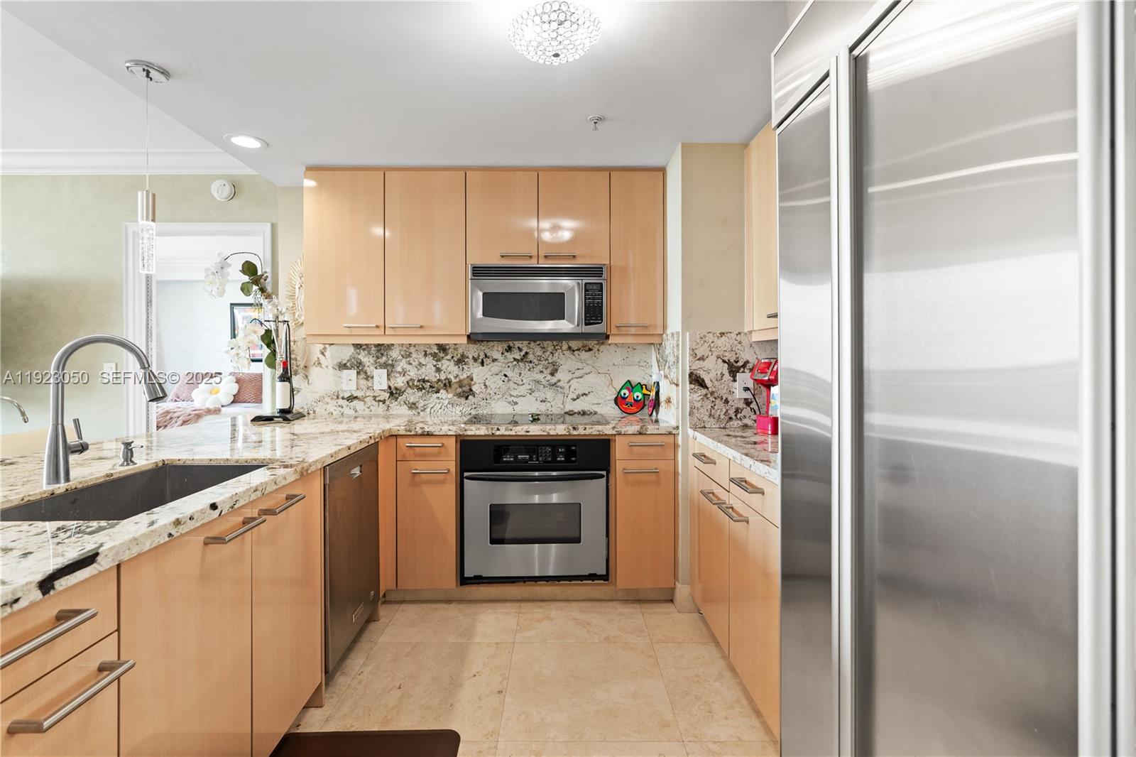 3350 Southwest 27th Avenue, Unit 1706 Coconut Grove, FL 33133 - Photo 5 of 32 a kitchen with refrigerator a sink and cabinets