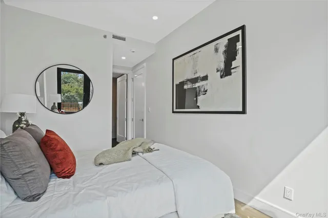 a bedroom with a large bed and a mirror