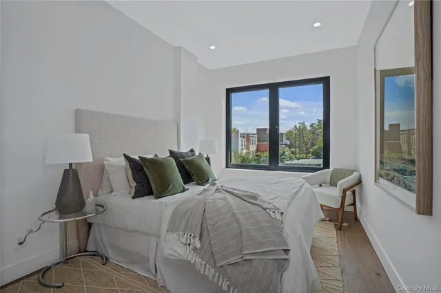 a bed sitting in a bedroom next to a window