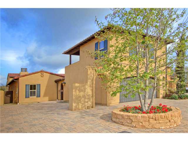 Warm rustic tones enhance the Tuscan styled architecture!  Convenient additional parking on beautiful stone pavers included with this home.