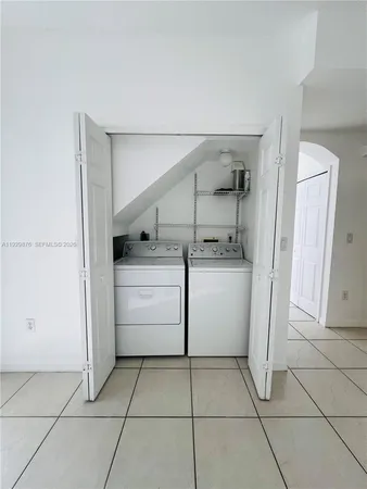 a utility room with cabinets washer and dryer