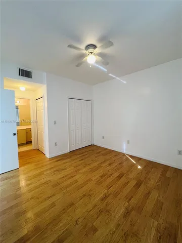 a view of an empty room and wooden floor