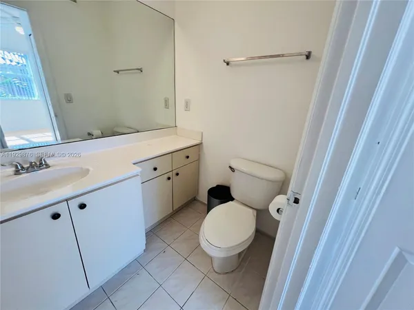 a bathroom with a toilet a sink and a mirror