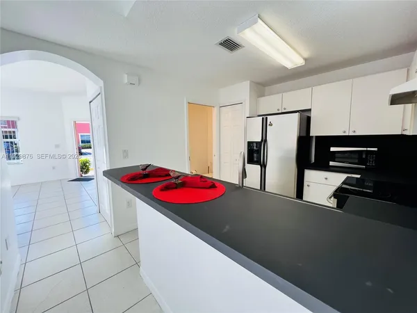 a kitchen with stainless steel appliances a refrigerator sink and stove