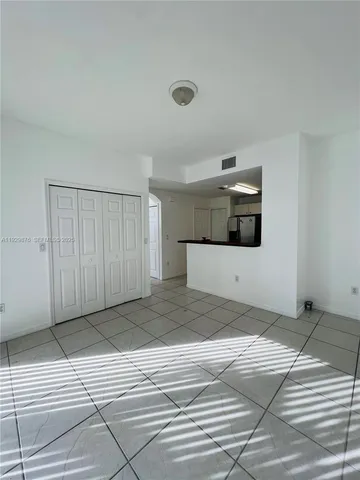 a utility room with cabinets washer and dryer