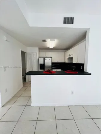 a view of kitchen with stainless steel appliances a refrigerator and a counter top space