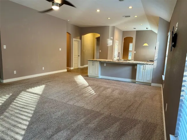 an open kitchen with a sink and a large mirror