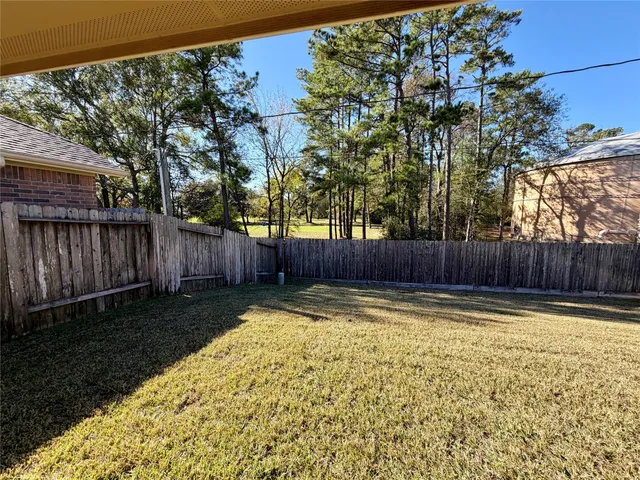 a view of a swimming pool with wooden fence