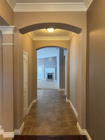 a view of a hallway with wooden floor and a door