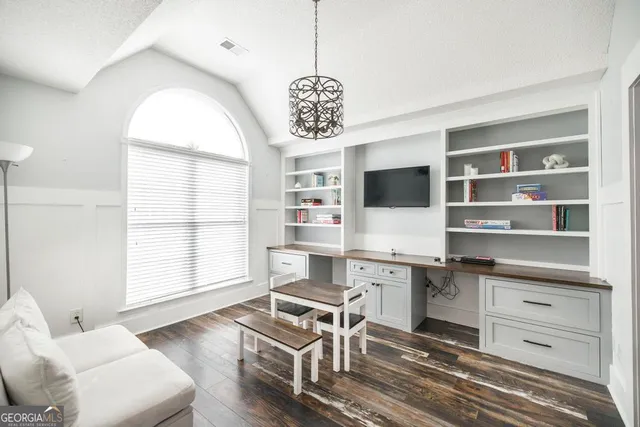 a workspace with furniture window and wooden floor
