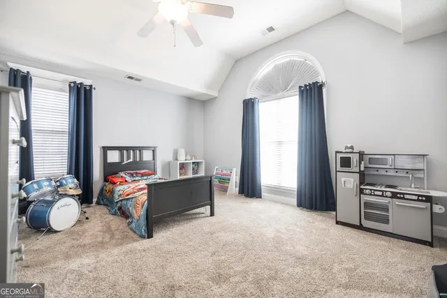 a living room with furniture oven and a window