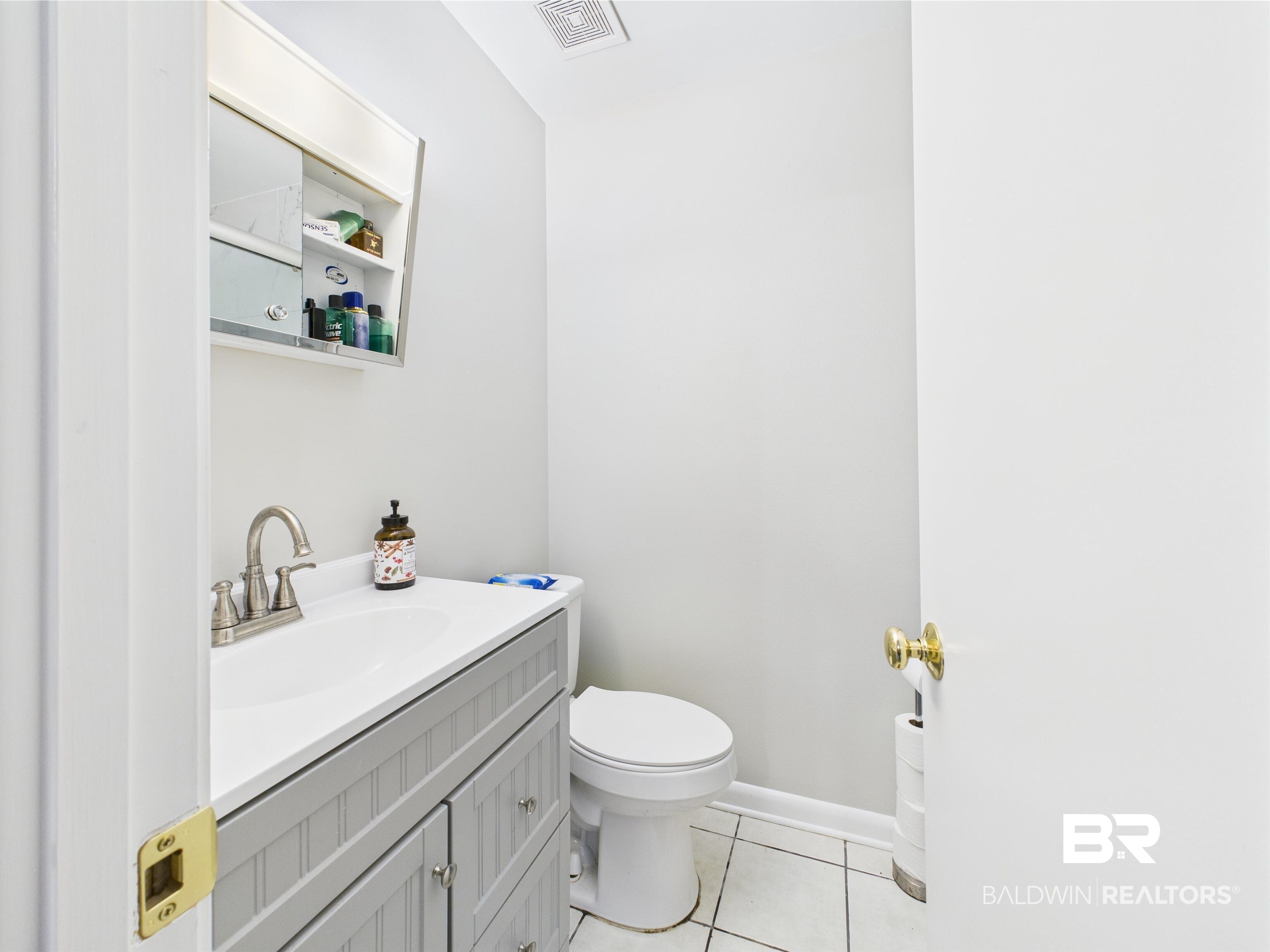 15148 Highland Circle Foley, AL 36535 - Photo 37 of 47 Bathroom with tile patterned flooring, toilet, vanity, and baseboards