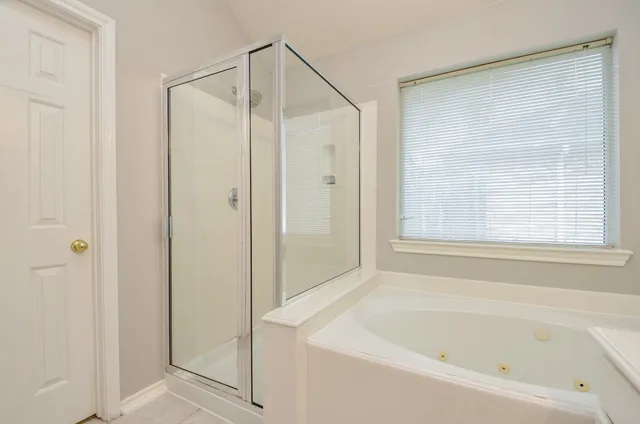 a bathroom with a sink a toilet a mirror and shower