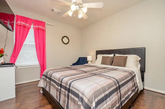 a bedroom with a bed and a window