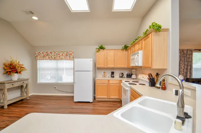 a kitchen with a sink and chairs