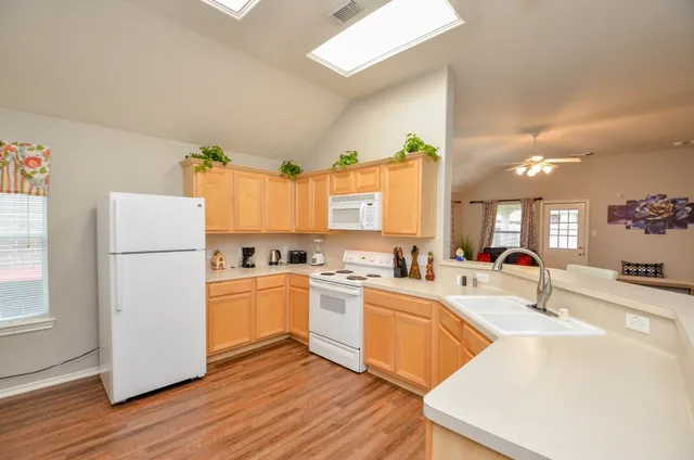 a kitchen with a sink appliances and cabinets
